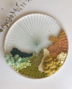 a white plate topped with lots of different types of yarn