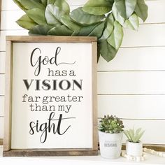 a sign that says god has a vision far greater than my sight next to a potted plant