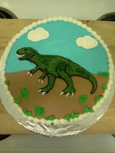 there is a cake with a dinosaur on it