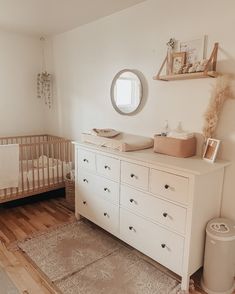 a baby's room with a crib and dresser