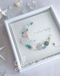 a sea glass bracelet in a white frame