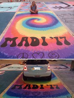 a woman sitting on the ground in front of a large chalk drawing that says daddy