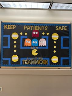 a bulletin board that says keep patients safe in front of a wall with pacman and pacman on it