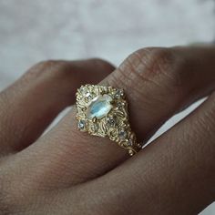 Step into a realm of ethereal beauty with our enchanting "Moonstone Moon Diamond" ring. This ring features a magical natural moonstone with a blue sheen when light reflects on it. Handcrafted in your choice of 14K and 18K gold. Only one available. All orders come in our Tippy Taste ring box. This ring is handmade and designed in NYC. 14K or 18K solid gold Natural oval moonstone. 6*4mm 12 Natural round diamonds. SI clarity, GH color, 0.11ct total carat weight 1.1mm width, 1.5mm thick band ** Tippy Taste Heirloom Collection is made to order. Please allow 3-4 week turnaround time. Shipping:Domestic: Free shippingInternational: Free shippingAll orders are insured, come with tracking, and with signature requirements. Please review our international shipping. Customization:- Interested in custom