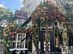 the outside of a building with flowers on it and a sign that says wildflower tavern