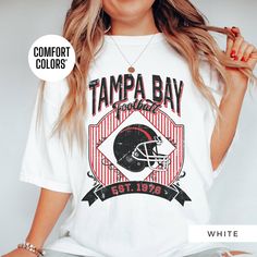 Show off your Tampa Bay Buccaneers pride with this retro t-shirt, designed for women who love vintage style! Featuring an oversized 90's look, this trendy t-shirt is perfect for game day or casual wear. Made from high-quality Comfort Colors fabric, it's an ideal gift for her, a girlfriend, or anyone who loves a classic boho vibe. This retro-style t-shirt is perfect for women who want to support their team in a stylish and comfortable way. Whether it's a sorority gift or a cute game-day outfit, t Buccaneers Shirt Women, Oversized T Shirt Dress, 90s Looks, Gameday Outfit, Retro Tshirt, Trendy Tshirts, Tampa Bay, Unisex Shirt, T Shirt Dress