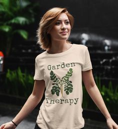 This garden themed jersey knit, short sleeve tee fits like a well-loved favorite. It is made from soft, Airlume combed and ring-spun cotton. These shirts have ribbed knit collars to bolster shaping and side seams to help retain shape. * 100% Airlume combed and ring-spun cotton* Tear away label * Lightweight fabric (4.2 oz/yd² (142 g/m * Tear away label * Runs true to size * Fiber composition: Solid colors are 100% cotton except for Ash - 99% cotton and 1% polyester, heather colors are 52% cotton Casual Crew Neck T-shirt For Gardening, Botanical Tshirt, Relaxed Fit T-shirt For Gardening In Spring, Casual Spring T-shirt For Gardening, Cotton Graphic Print T-shirt For Gardening, Short Sleeve T-shirt With Plants Print For Gardening, Garden Therapy, Gardening Gift, Knit Short