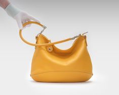 "I made this hobo bag of soft Italian pebbled leather of excellent quality in yellow. If you want to change the color, just select it in the menu when buying. Want to resize your bag? Let's discuss this possibility in personal correspondence. This soft comfortable bag is also quite roomy. You can put in it all the things that every woman needs throughout the day. The soft form and two detachable handles (a short round handle and a long crossbody strap ) make this bag comfortable for daily use. T Casual Purse, Round Handle, Leather Hobo Bag, Yellow Leather, Leather Hobo, Glasses Case, Crossbody Strap, Hobo Bag, Every Woman