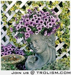 there is a small statue with purple flowers in its head and on it's side