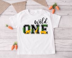 a white t - shirt with the words wild one printed on it and carrots next to it