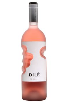 a bottle of wine that is on a white surface with the label dille in front of it