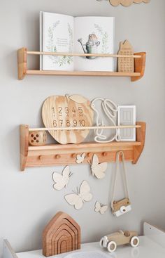 two wooden shelves with magnets on them in a child's playroom area