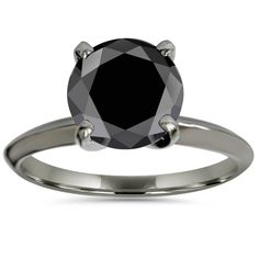 a black diamond engagement ring on a white background with the center stone set in 18k white gold