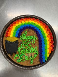 there is a cake that says happy st patrick's day with a pot of gold and a rainbow