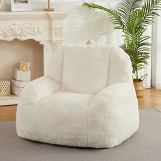 a living room with a large white bean bag chair next to a potted plant