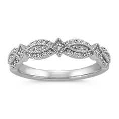 a white gold wedding ring with diamonds on it's sides and leaves in the middle