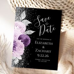 a black and white save the date card with purple flowers