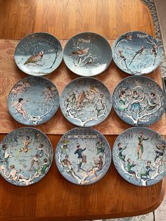 nine plates with different designs on them sitting on a table