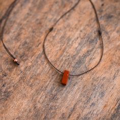 Keep it simple with this desert red jasper necklace. Boasting a relaxed fit, this necklace features a red jasper pendant suspended on our waterproof cord. It is beautifully accented with brown glass beads along the length of the necklace. Embrace the carefree spirit of a hippie chic vibe with this perfect accessory.  This necklace offers complete adjustability with a sliding knot closure, allowing you to wear it as a choker or as a longer necklace. The cord softly drapes the upper spine, forming Minimalist Brown Necklace For Everyday Use, Brown Waxed Cord Necklace For Everyday, Everyday Brown Waxed Cord Necklace, Brown Minimalist Necklace With Adjustable Cord, Minimalist Brown Necklace With Adjustable Cord, Minimalist Brown Necklace For Everyday, Red Jasper Necklace, Surfer Jewelry, Sliding Knot Closure