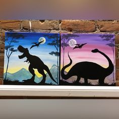 two paintings of dinosaurs painted on canvases in front of a brick wall with a full moon