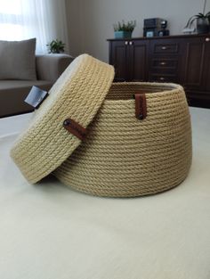 two woven baskets sitting on top of a bed