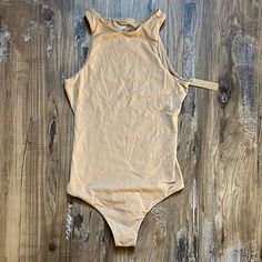 Brand New With Tags!!! Size Xs Skims Fits Everybody High Neck Sleeveless In Ochre. E Sleeveless Beige Bodysuit For Summer, Chic Sleeveless Beige Bodysuit, Brown Sleeveless Bodysuit For Summer, Sleeveless Brown Bodysuit For Summer, Sleeveless Brown Bodysuit For Spring, Sleeveless Brown Summer Bodysuit, Brown Sleeveless Bodysuit, Ochre Color, High Neck Bodysuit