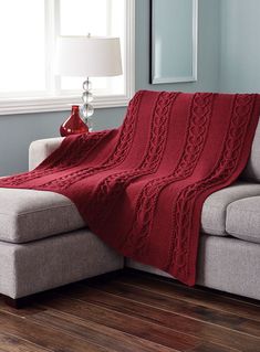 a couch with a red blanket on top of it