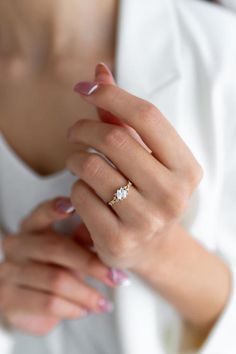 a woman wearing a diamond ring on her finger