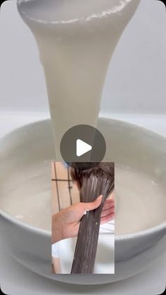 a person is pouring milk into a bowl with long brown hair in it and the video appears to be being viewed from above