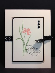 a white card with pink flowers on it and a black string attached to the front