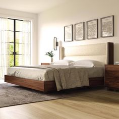 a bedroom with white walls and wooden floors