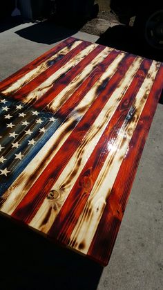 an american flag made out of wood sitting on the ground