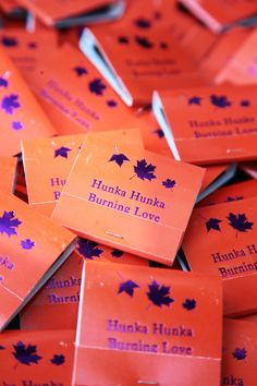 many orange business cards with purple maple leaves on them