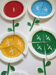 three paper plates with different numbers on them and one has a flower growing out of it