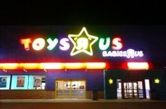 a toy store lit up at night with neon lights