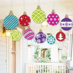 christmas ornaments hanging from the ceiling on a porch