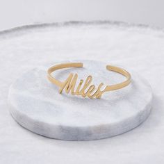 Turn any unique handwriting into a bold cuff. Use a child’s name, loved one’s signature, word from a special letter, or new last name to create a bold everyday cuff to wear on its own or layered with other favorite bracelets. Remember that you can always choose our default signature font and customize with any word or name. 14k solid gold customers will be sent a design proof for approval before moving into production. /!/ Size: One size, adjustable, band width is 3mm wide Available in sterling Unique Handwriting, Special Letters, Custom Signature, Signature Rings, Signature Bracelet, Signature Fonts, Silver Rose Gold, Silver Roses, Handwriting