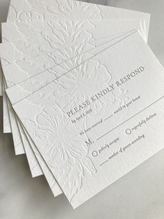 four white wedding cards with the words classy kindly respond printed on them, sitting on top of each other