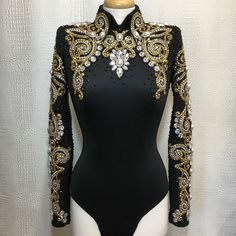 a black bodysuit with gold and silver sequins