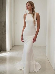 a woman in a white wedding dress posing for the camera with her hands on her hips