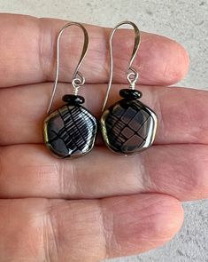 black metallic print earrings   modern look   czech glass boho dangle earrings * Czech glass flat off-round disc beads - 15mm * shiny opaque black with silver metallic prints - each bead is unique * small black glass disc sits on top * antiqued silver plated hook ear wires * total length - 1 1/2" * you can enter my shop here:    gypsydangles.etsy.com Metallic Prints, Exeter, Modern Earrings, Etsy Earrings Dangle, Black Metallic, Black Glass, Ear Wires, Gemstone Earrings, Czech Glass