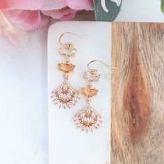 Make a statement with these peach statement earrings. Whether you are a boho bride, wedding guests or going to a fancy event, these long drop earrings are the perfect vintage inspired piece to complement your ensemble. They feature peach crystal stones with art deco inspired fan dangles, these earrings will make you feel glamorous and beautiful.  They are finished with 14K gold filled ear wires, suitable for the most sensitive ears. ✨ Suggested occasion for wear : wedding guest, gala, brunch, Valentine's Day, prom DIMENSION: ----------------   Earrings : 0.5 inches x 1.8 inches Materials : glass crystal with gold plated setting, 14K gold filled ear wire ✨ Also available in pink/purple https://ysmdesigns.etsy.com/listing/1721033091 ✨For other glam earrings, click here : https://www.etsy.com Feminine Dangle Bridal Earrings For Party, Gold Bohemian Crystal Earrings For Wedding, Bohemian Gold Crystal Wedding Earrings, Bohemian Crystal Drop Earrings For Wedding, Feminine Crystal Drop Earrings For Wedding, Delicate Chandelier Earrings For Party, Bohemian Dangle Crystal Earrings For Wedding, Orange Drop Earrings For Wedding, Feminine Dangle Earrings For Wedding