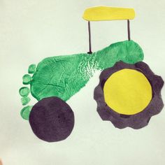 a child's drawing of a tractor made out of paper and colored construction material