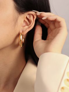 Take a risk with our Clara Earrings! These bold hoop earrings make a statement for every occasion. Lightweight and daring, these earrings are the perfect accessory for any adventure! …………………………………. D E T A I L S• Materials: Stainless steel, 18k gold plating.• Hoop Diameter: 3 cm (1.2 inches) • Width: 1 cm (0.7 inches)• Length: 3 cm (1.2 inches)• This product is hypoallergenic, water and tarnish resistant Modern Hoop Clip-on Earrings, Luxury Everyday Small Hoop Earrings, Chic Polished Finish Hoop Earrings For Gift, Chic Polished Finish Hoop Earrings As Gift, Chic Polished Hoop Earrings As Gift, Modern Hoop Earrings With Plating, Polished Finish Drop Clip-on Earrings, Modern Small Hoop Earrings With Plating, Modern Small Hoop Plated Earrings