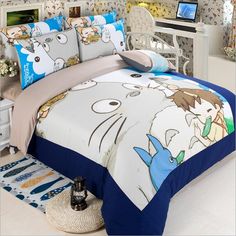 a bed room with a neatly made bed and cartoon characters on the comforter set