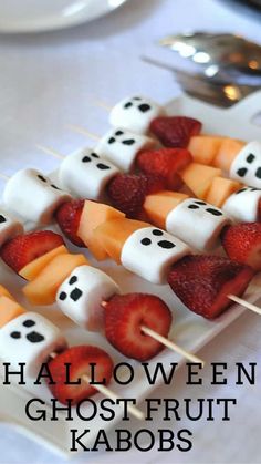 halloween ghost fruit kabobs on a white plate