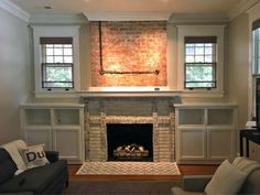 a living room filled with furniture and a fire place in the middle of a room