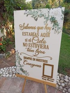 a white sign sitting on top of a wooden easel