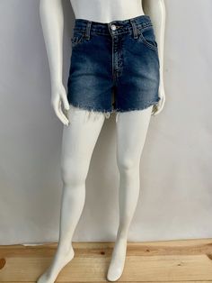 "Vintage Women's 90's Levi's 517, High Waisted, Cut Off's, Denim, Shorts (S) 669 These Ladies Shorts come in a medium blue colored wash cotton and have three front pockets, two back pockets and are high waisted with belt loops, front button closure with signature Levi's red tab logo and fringe front. 100% Cotton Made in Guatemala *These shorts are in excellent condition. Size: (S) Modern Day 4 (Tag Size: 5 jr M) Waist: 30\" Length: 12 1/2\" (unfolded) Hips: 34\" Rise: 10\" (front) 13\" (back) In 90s Denim Blue Mid-rise Bottoms, 90s Mid-rise Denim Blue Bottoms, Casual Dark Wash Shorts With Frayed Hem, Dark Wash Bottoms With Belt Loops, Dark Wash Shorts With Belt Loops, Retro Dark Wash Short Length Jeans, Retro Straight Leg Bottoms With Frayed Hem, Relaxed Fit 90s Washed Bottoms, 90s Style Washed Bottoms With Relaxed Fit