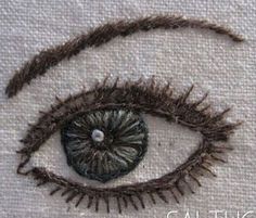 the eye is made out of yarn and has been stitched on to it's side